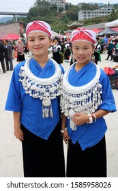 Kaili, China - October 24, 2019: At the Lusheng Festival of Zhongan Town, portrait of two young girl, wearing typical colored clothes