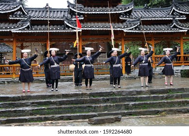 Kaili, China - October 26, 2019: At Fanpai Village, people, wearing typical clothes and headgear of Miao minority, are dancing outdoor