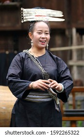 Kaili, China - October 26, 2019: At Fanpai Village, portrait of a woman, wearing typical clothes and headgear of Miao minority
