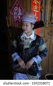 Kaili, China - October 29, 2019: At Hundreds of Birds Miao Village, portrait of a girl, wearing typical clothes and headgear of Miao minority