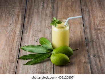 Kairi panha OR Panna OR Raw Mango Drink is a traditional and most popular Indian summer beverage served in a glass over colourful or wooden background. Selective focus