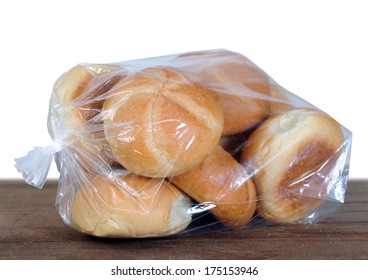 Kaiser Bread In Plastic Bag On The Table At Market Place