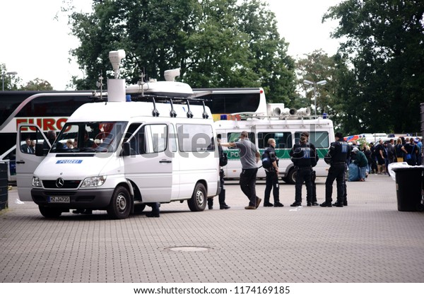 KAISERSLAUTERN, GERMANY - AUGUST 25: Police car\
with police officers in front of the Fritz-Walter-Stadions before\
the game between the 1. FC Kaiserslautern and the Karlsruher SC of\
the 3. Bundes
