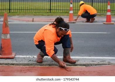 KAITAIA, NZ JAN 23:Road Workers Use Finishing Trowel Tool On Jan 23 2014.The Road Maintenance Crew Has The Responsibility For The Day-to-day Maintenance Needs Of The Road System.