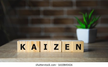 Kaizen improvement sign made of blocks on a wooden desk in a bright room. - Shutterstock ID 1610845426