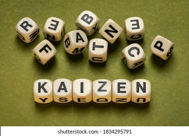 Kaizen Word Abstract In Wooden Letter Cubes Against Green Handmade Paper In Green Tones,  Japanese Continuous Improvement And A Change For Better Concept