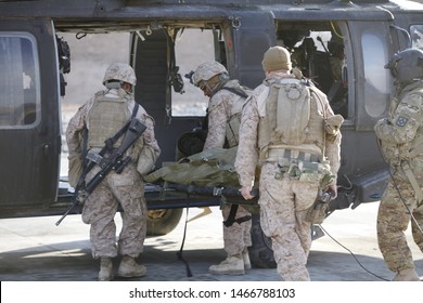 Kajaki, Afghanistan - February 21, 2012: US Military Personnel Load A Wounded Marine Onto A UH-60 Helicopter.