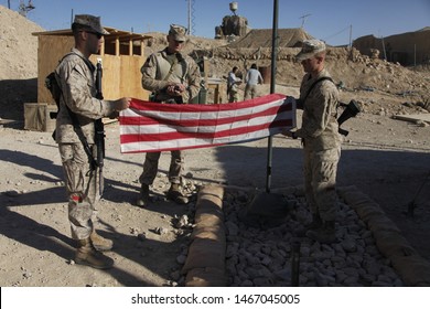 Kajaki, Afghanistan - March 20, 2012: US Marines Fold A Bullet Riddled American Flag.