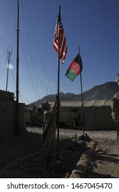 Kajaki, Afghanistan - March 20, 2012: US Marines Raise The American Flag Next To The Afghan Flag Upon A US Military Forward Operating Base. 