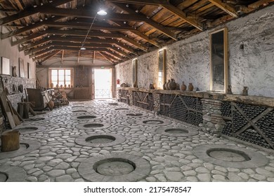 Kakheti, Georgia - September 23, 2021: Interior Of The Traditional Wine Cellar With Qvevri, Earthenware Vessels In Ground, Georgia. Production Of The Amber Wine Using Kvevri. 