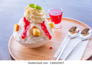 Kakigori strawberry cheesecake. Bingsu strawberry cheesecake from top-view.
Bingsoo: white smoothie ice, cream, strawberry, Sweetened condensed milk mixed of Korean dessert in bowl on wood table - Powered by Shutterstock