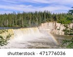 Kakisa River Lady Evelyn Falls in morning direct sunlight and rainbow - Northwest Territories, Canada