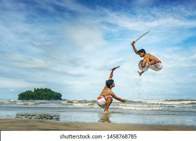 Kalaripayattu -Artists performing Kerala's oldest traditional martial art form on a beach in Kerala, India