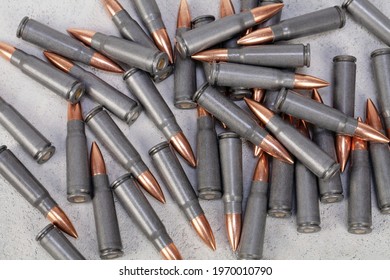 Kalashnikov Ak Gun 7,62 Mm Bullets On Grey Concrete Surface Background