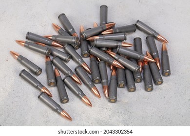 Kalashnikov Ak Gun 7,62 Mm Bullets On Grey Concrete Surface Background