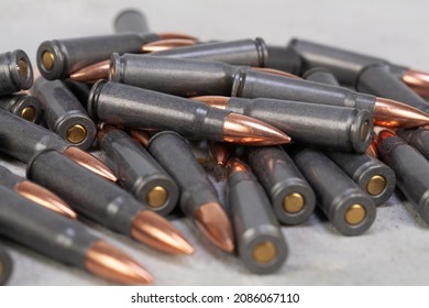 Kalashnikov Ak Gun 7,62 Mm Bullets On Grey Concrete Surface Background