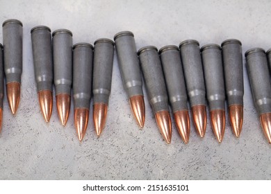 Kalashnikov Ak Gun 7,62 Mm Bullets On Grey Concrete Surface Background