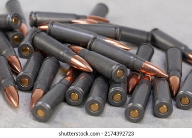 Kalashnikov Ak Gun 7,62 Mm Bullets On Grey Concrete Surface Background