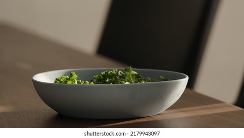 Kale In Blue Bowl On Walnut Table Making Salad