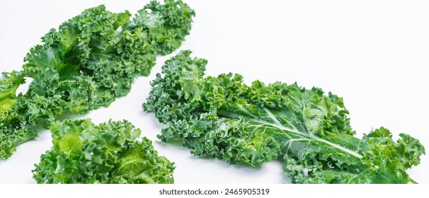 Kale, a fresh, delicious green leafy vegetable, contains antioxidants for good health. Kale isolated on white background - Powered by Shutterstock