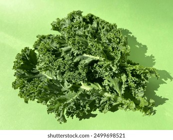 Kale leaf salad vegetable isolated on green background. Creative layout made of kale closeup. Food concept. - Powered by Shutterstock