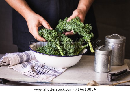 Kale leafy greens vegetable box hold in hands wash black wall raw kale ready to prepare food hand greens leafy