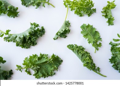 Kale leaves on white background. Top view. Kale leaves with copy space for text. Background of kale leaves. Kale on white background.