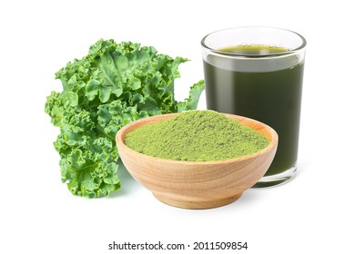 Kale powder in wooden bowl with glass of green smoothie juice and fresh kale vegetable isolated on white background.