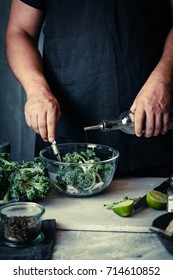 Kale recipes. Man preparing kale salad leaf cabbage copy space cooking process nutrition healthy super food concept 