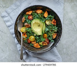 Kale, Roasted Yams And Avocado Salad On Stone Background