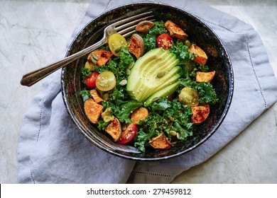 Kale, Roasted Yams And Avocado Salad On Stone Background