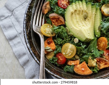 Kale, Roasted Yams And Avocado Salad On Stone Background