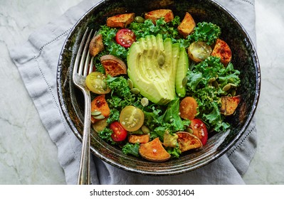 Kale, Roasted Yams And Avocado Salad On Stone Background