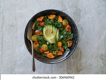 Kale, Roasted Yams And Avocado Salad On Stone Background
