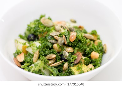 Kale Salad With Pear, Pumpkin Seed, Blueberry In White Bowl On White Background