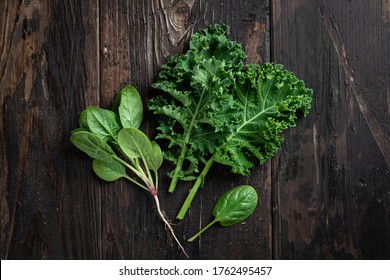 Kale And Spinach On A Dark Wooden Background