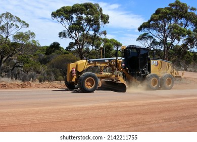 KALGOORLIE - MAR 15 2022:Motor Grader flatting a dirt road surface in Western Australia,one of the largest geographically-spread road system in the world,18,500Km of road spread over 2.5 million km2.