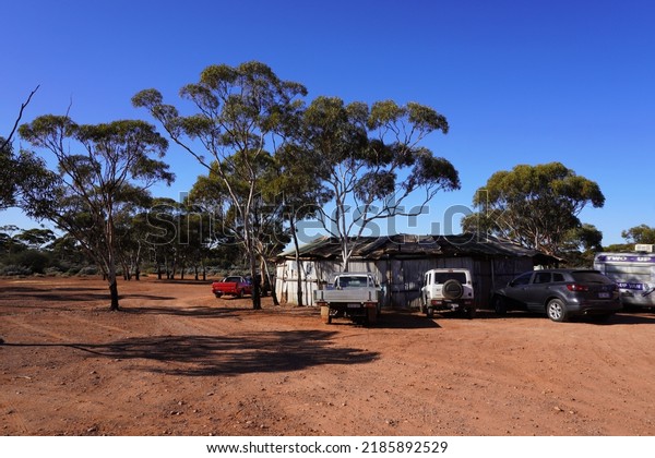 Kalgoorlie,\
Western Australia, Australia, June 26, 2022. Outback Landscape with\
Cars surrounding the local Two Up\
Shed