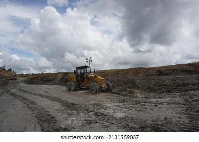 kalimantan, indonesia, 10 february 2022, photo of a grader or heavy equipment used for road repair in a coal mine in yellow color and has the brand ''SDLG''