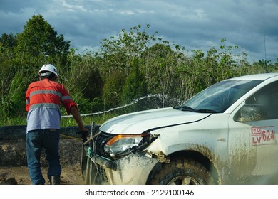 Kalimantan, Indonesia, February 10, 2022, Is A Mining Employee Who Is Flushing A Mining Facility Car, Washing A Hot Sun Car