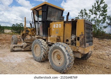Kalimantan, Indonesia, February 26, 2022, is a photo with the main object, namely a yellow heavy equipment grader with the brand ''Trakindo Cat'' which is quite old