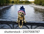 Kaliningrad, Russia, bronze statuette of homlin grandfather Karl on the Honey Bridge in a warm hat, city brownie, local landmark