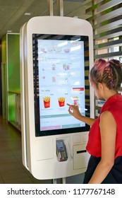 KALININGRAD, RUSSIA - CIRCA SEPTEMBER, 2018: Woman Use Self Ordering Kiosk In McDonald's Restaurant. McDonald's Is An American Fast Food Company.