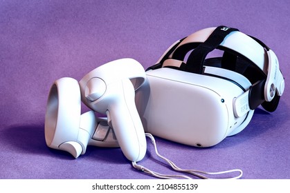 Kaliningrad, Russia - january 10.2022: white new generation VR headset on violet 'very peri' background. Oculus Quest 2 virtual reality headset
