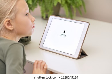 Kaliningrad / Russia - January 5 2020:  Sad little girl sitting near the Apple iPad Air with the inscription "Time limit You have reached your limit on Minecraft" The problem of gambling addiction.