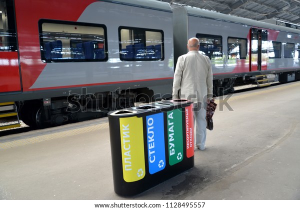 KALININGRAD, RUSSIA - JUNE 20, 2018: The open\
container for separate collecting garbage costs on the platform of\
the Southern station. The Russian text - plastic, glass, paper, not\
sorted waste