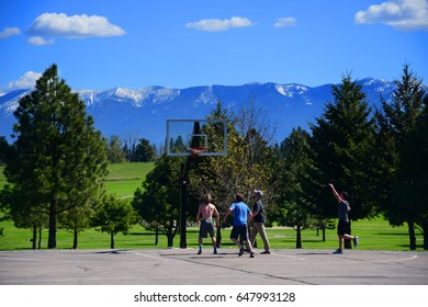 KALISPELL, MONTANA, USA - May 9, 2017: College Students At Flathead Valley Community College Playing A Pick Up Game Of Basketball On Campus.