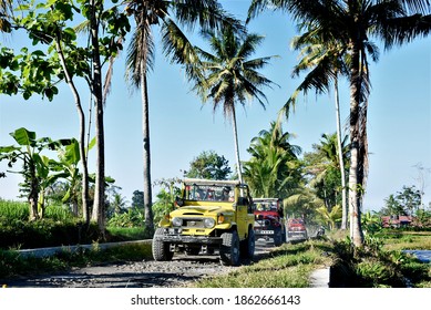 Kaliurang Yogyakarta, Indonesia - August 19, 2018: A Convoy Of Merapi Tour Jeep Crossing Village Street In Kaliurang Yogyakarta