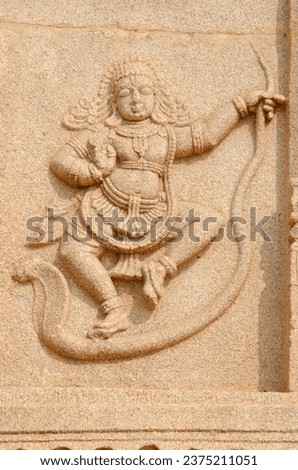 Kaliya mardana Krishna sculpture  on exterior wall of Ramachandra temple, Hampi, Karnataka, India