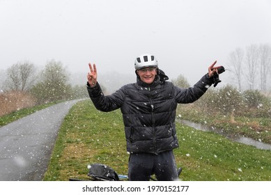 Kalken, Flemish Region - Belgium - 04 04 2021: Forty Year Old Man With Bike And Helmet Standing In A Snow Storm In A Nature Reserve